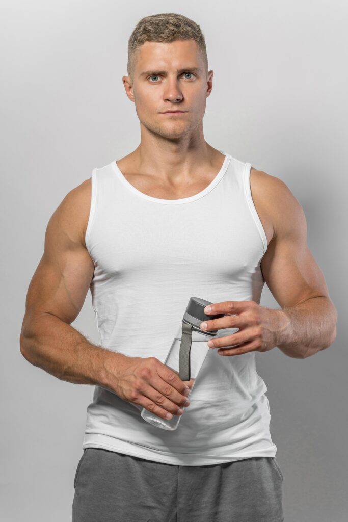 front-view-fit-man-tank-top-holding-water-bottle